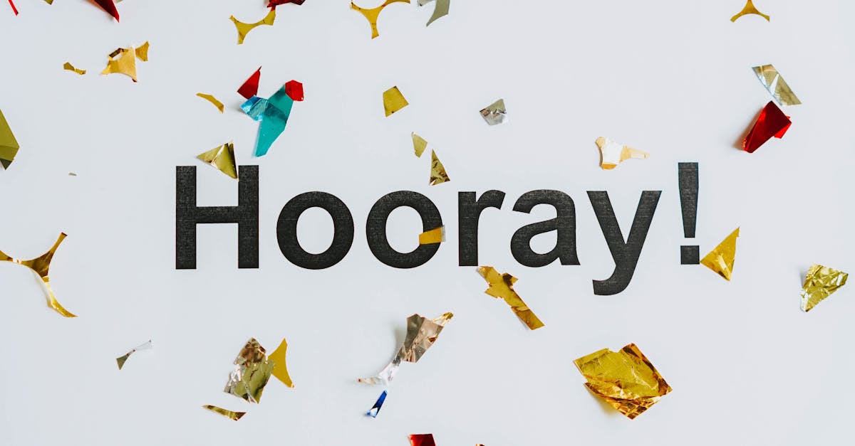 Vibrant confetti falling around the word 'Hooray!' on a white background, celebrating success and happiness.